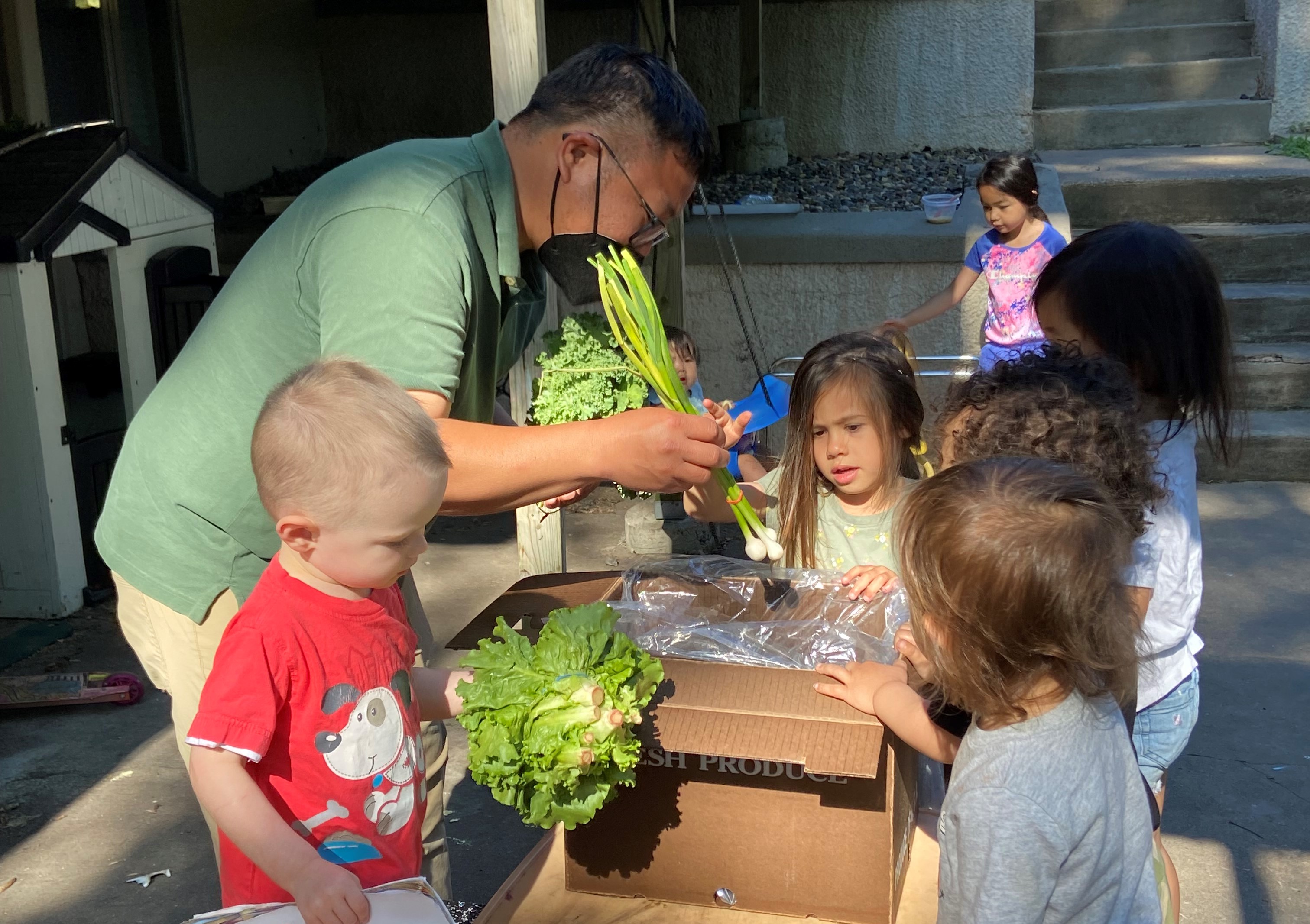 Janssen Hang delivers box of vegetables to toddlers at in-home early care