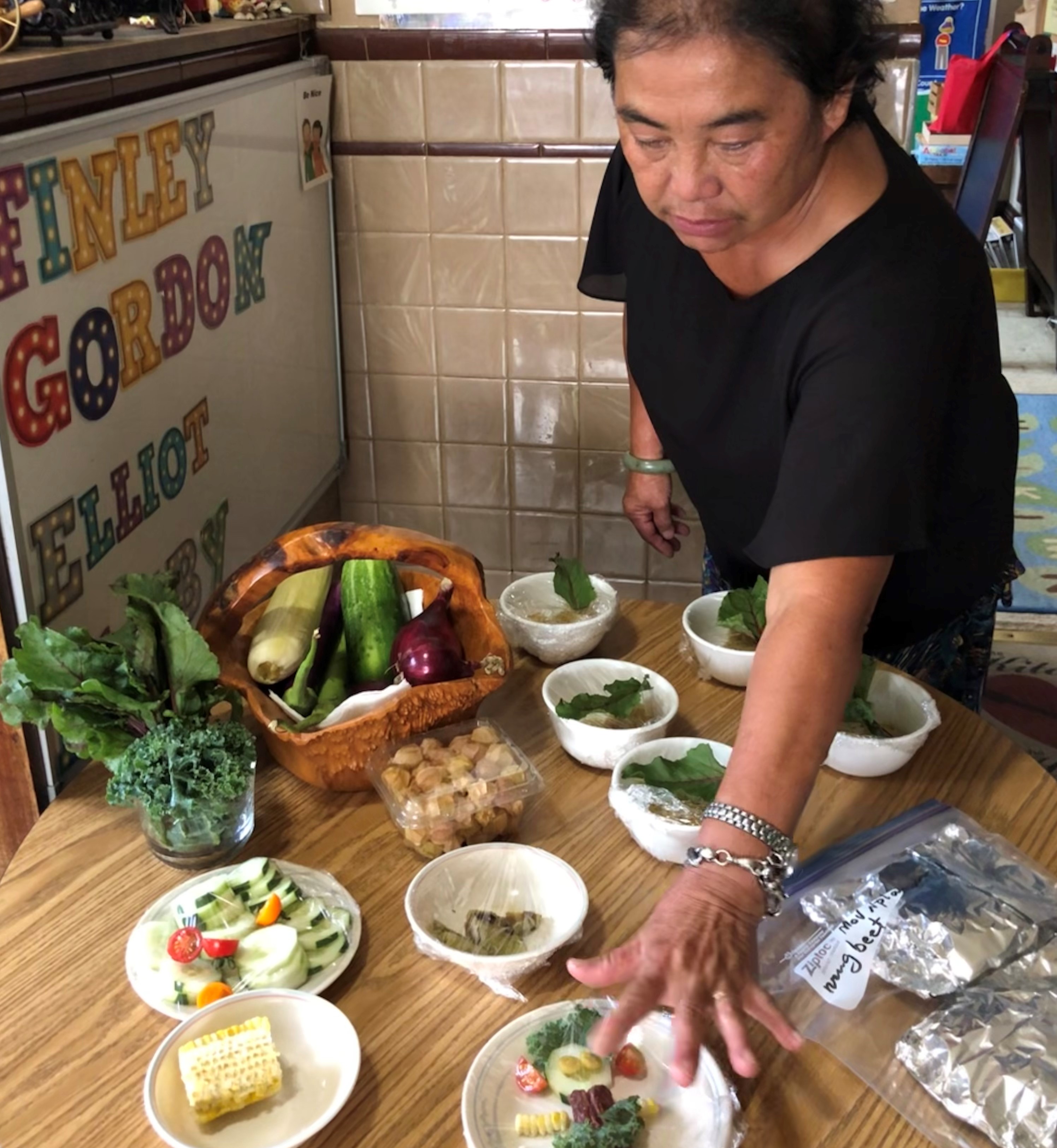 Souvanh Thao presents plates of food