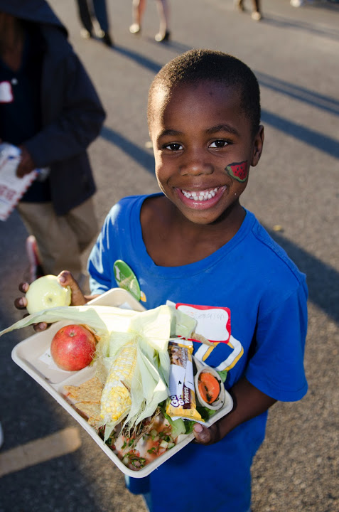 Kid with tray of local food