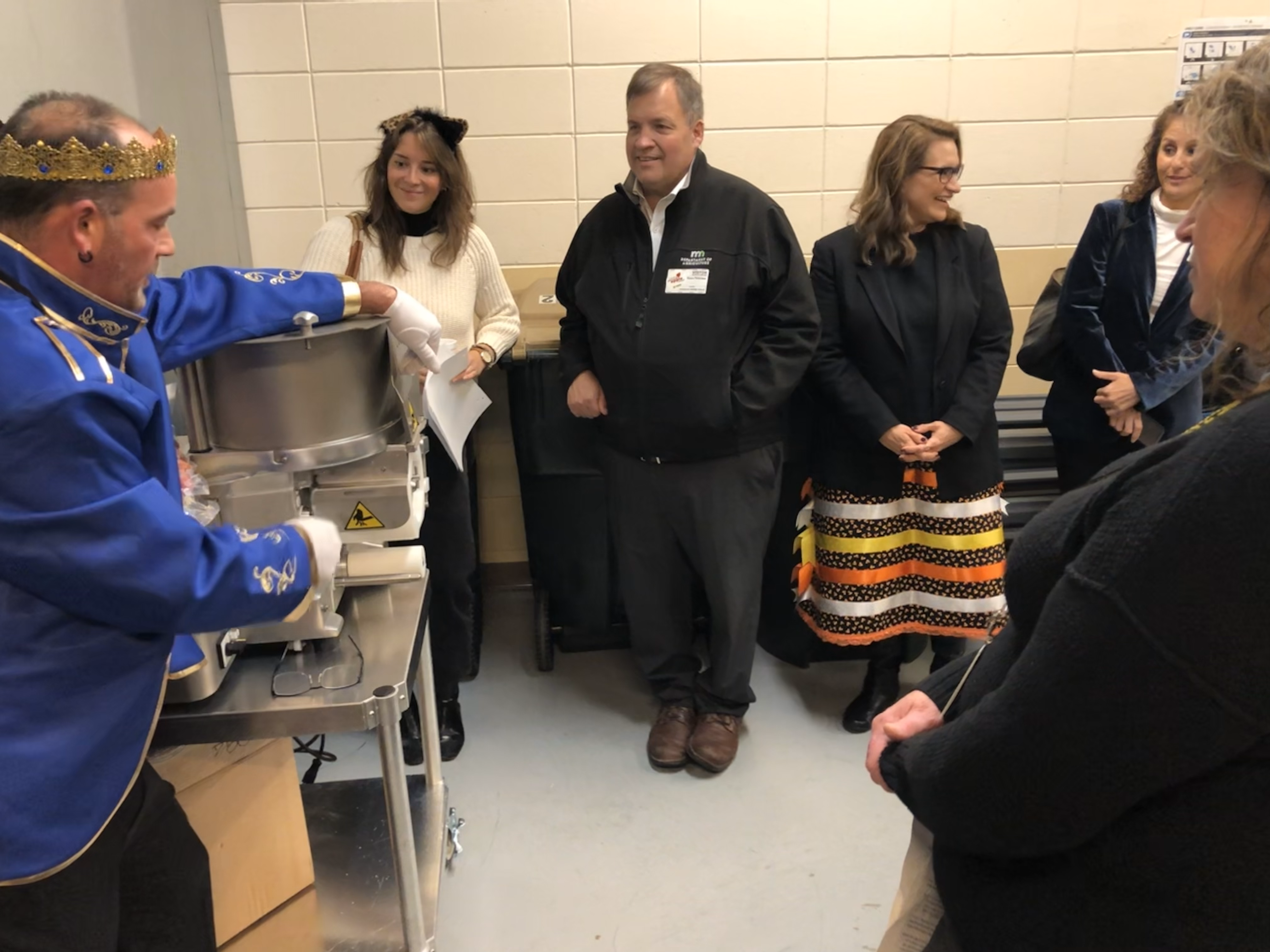 At a Halloween Farm to School Month event, kitchen staff at Hutchinson Middle School show MDA Commissioner Thom Petersen and Lt. Governor Peggy Flanagan kitchen eqipment purchased with a Farm to School grant.