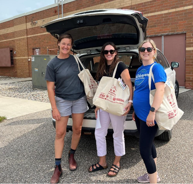 A group of women standing in front of a car with bags in the trunk

AI-generated content may be incorrect.