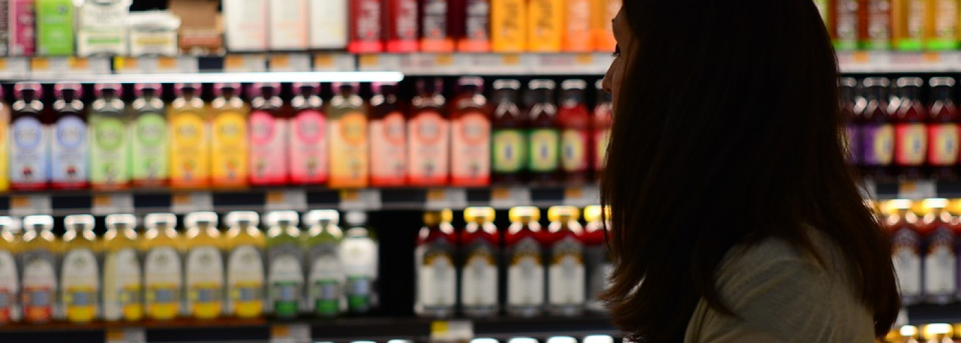 Lady in the grocery store shopping for beverages