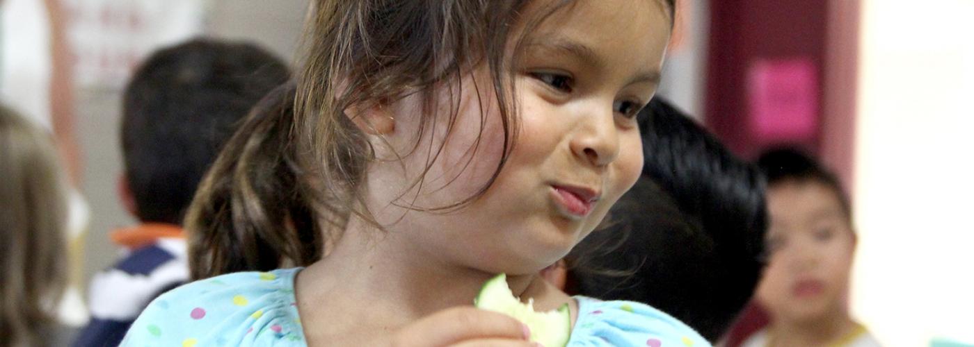 girl eating a cucumber 