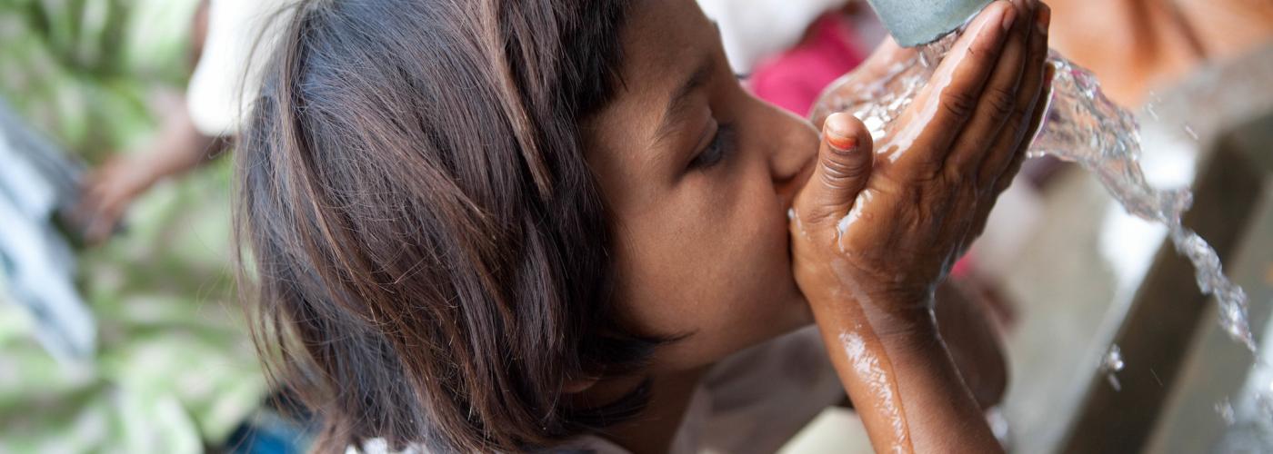 Young child drinking water 