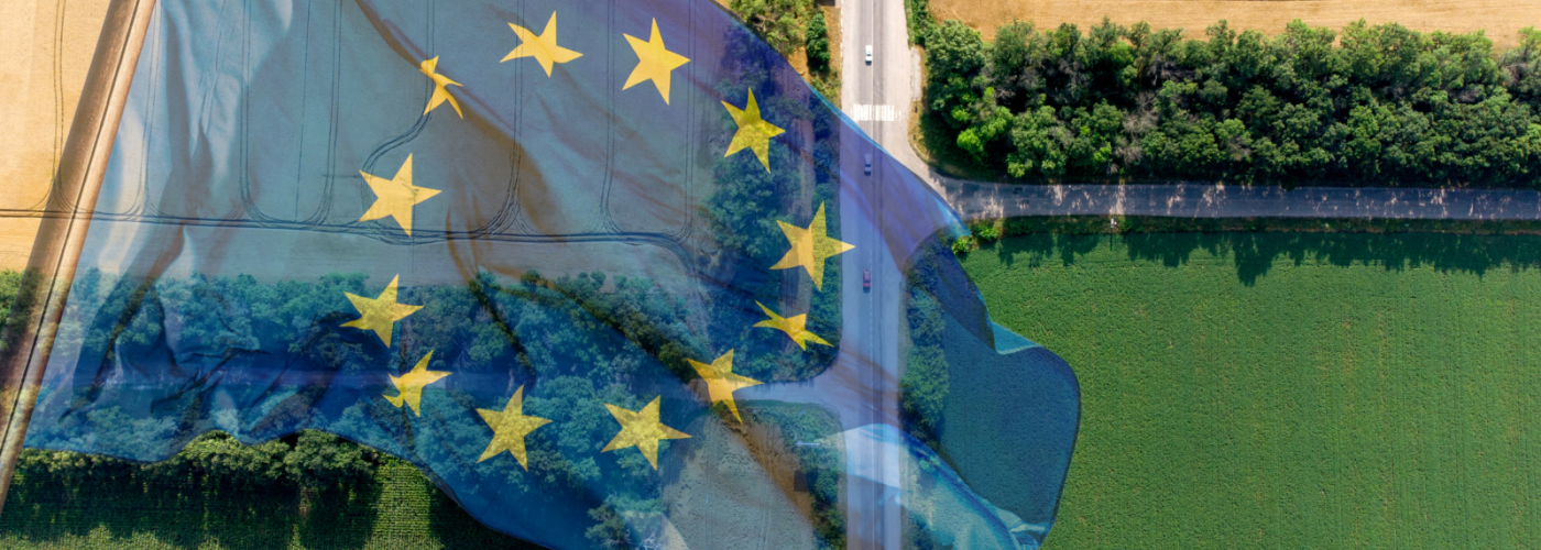 Aerial view of farm fields and road with EU flag overlaid