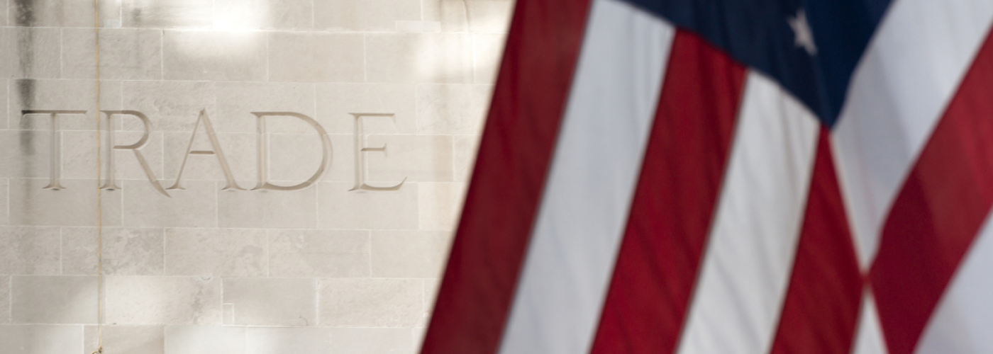 U.S. flag in front of the word TRADE