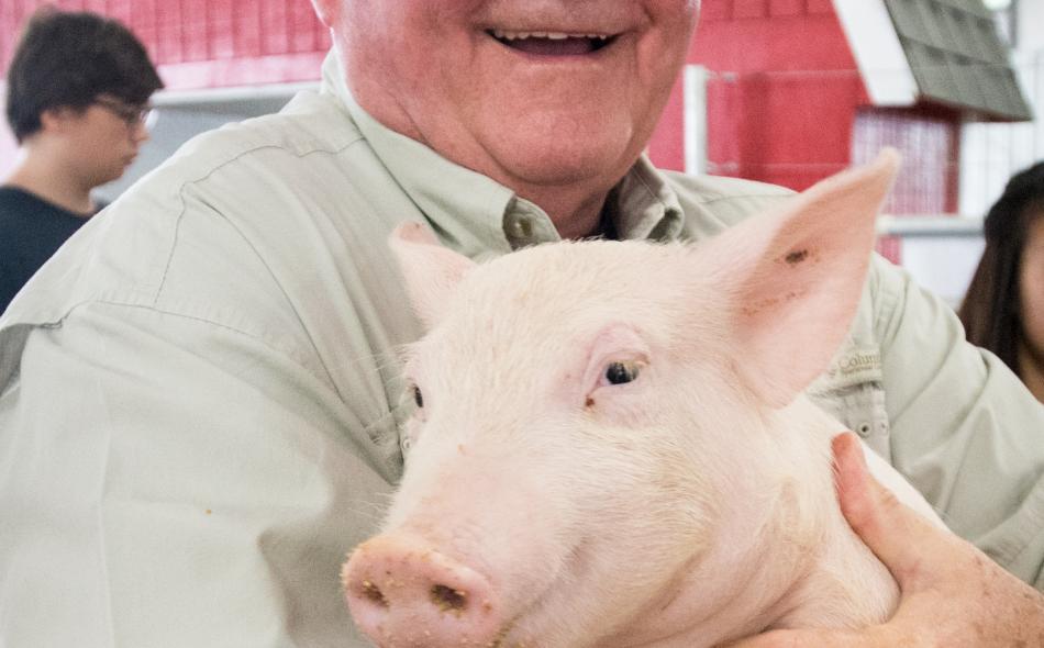Sonny Perdue holding a pig