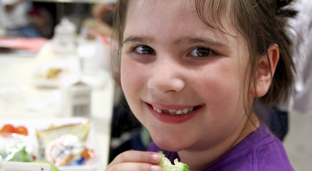 Roseville Cucumber Crunch- girl with a cucumber