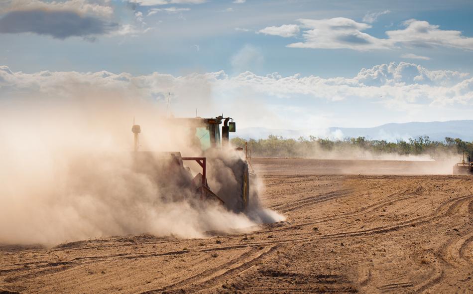 Tractor in a dry, dusty field