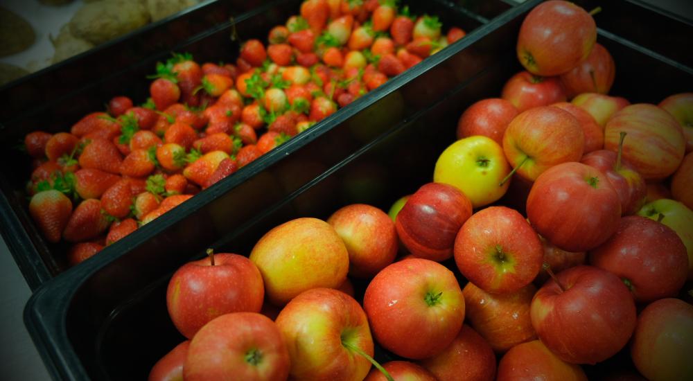 Locally grown apples and strawberries in a school cafeteria