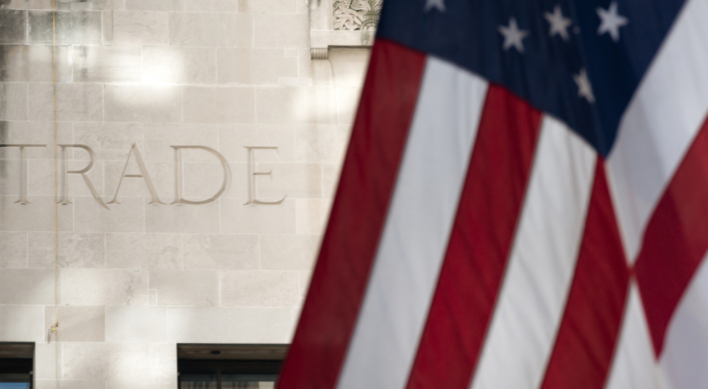 U.S. flag in front of the word TRADE