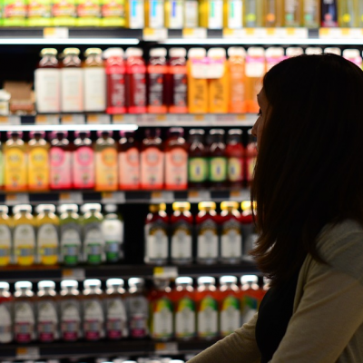 Lady in the grocery store shopping for beverages