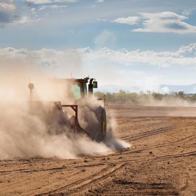 Tractor in a dry, dusty field
