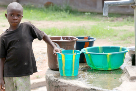 kid with water buckets