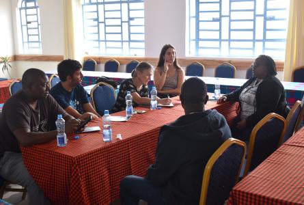 Group of people sitting at a table talking
