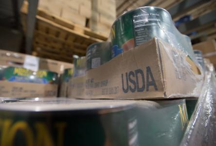 Cans on food aid shelf labeled USDA
