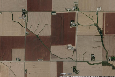 google maps aerial view of rural Iowa with several long white buildings that may be CAFOs.