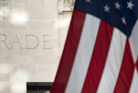 U.S. flag in front of the word TRADE